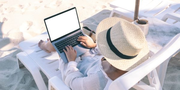 A digital nomad working on a laptop with a view of Istanbul, reflecting the legal considerations of remote work in Turkey, advised by a Turkish lawyer.